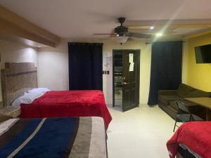 a hotel room with two beds and a couch at hotel angeles in San Luis Río Colorado
