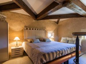 a bedroom with a large bed in a room at Gites de Gondières in Saint-Éloi