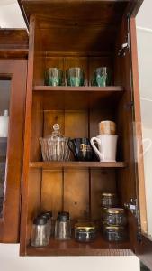 a cabinet with bowls and other dishes in it at LAZA villa in Nuwara Eliya +34 photos