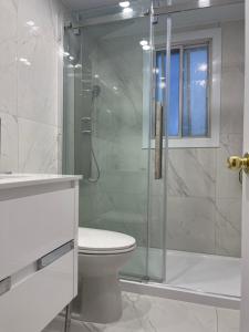 a bathroom with a glass shower and a toilet at 3 bedroom central location montreal close to airport in Laval