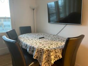 a dining room table with a flowered table cloth on it at 3 bedroom central location montreal close to airport in Laval