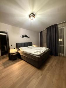 a bedroom with a large bed and a ceiling at Elite Apartments Complex Iglika Borovets in Borovets