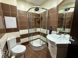 a bathroom with a toilet and a sink and a shower at Elite Apartments Complex Iglika Borovets in Borovets