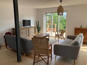 a living room with a couch and a table at Chez David à Paimpol in Paimpol