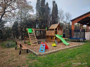 a playground with a play set and a slide at Appartement insolite au Ranch Wamakiti in Le Soler +2 photos