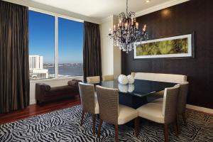 a dining room with a table and chairs and a large window at Loews New Orleans Hotel in New Orleans