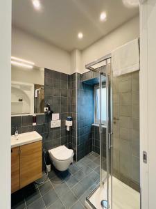 a bathroom with a toilet and a sink and a shower at Ruanera in Catania
