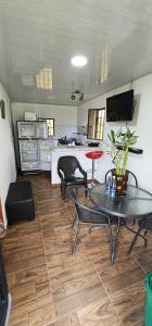 a room with a table and chairs and a kitchen at Casa de campo Rega in Falan +23 photos