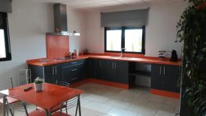 a kitchen with black cabinets and a table and a sink at La villa de Naomi in Chella