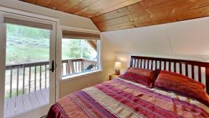 a bedroom with a bed and a large window at Palmers Dr 1010 in Silverthorne