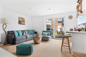 a living room with a couch and a table at Ferienwohnung HafenloungeOlpenitz in Olpenitz