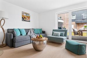a living room with a couch and a table at Ferienwohnung HafenloungeOlpenitz in Olpenitz +20 photos