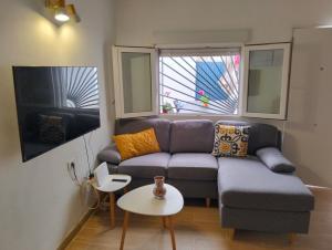 a living room with a couch and a table at La casita in Arafo