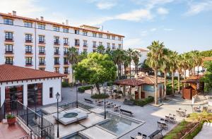 an aerial view of the courtyard of a large white building at PortAventura Hotel Roulette - Includes unlimited access to PortAventura Park & 1 access to Ferrari Land in Salou +34 photos
