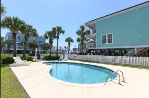 uma piscina em frente a uma casa com palmeiras em A Dream em Myrtle Beach