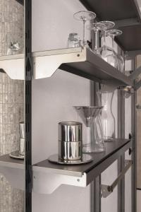 a shelf with glass items on it at Wolne Pokoje I Boutique Apartments in Wrocław