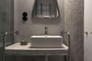 a bathroom with a white sink and a mirror at Wolne Pokoje I Boutique Apartments in Wrocław +26 photos
