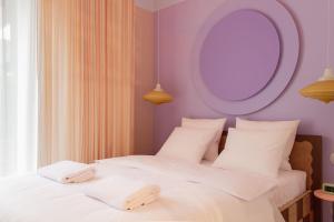 two beds in a bedroom with a mirror on the wall at Wolne Pokoje I Boutique Apartments in Wrocław