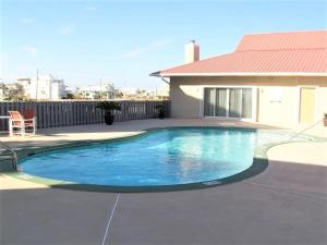 a swimming pool in front of a house at Sunset Heaven in Navarre