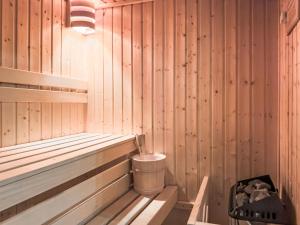 a wooden sauna with a trash can in it at Chalet Gingembre 8 by Interhome in Nendaz