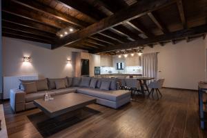 a living room with a couch and a table at Eptalofos Mountain Resorts in Eptalofos