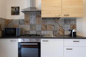 a kitchen with a sink and a stove top oven at Louis House ad Agerola per Amalfi Positano Pompei in Agerola +42 photos