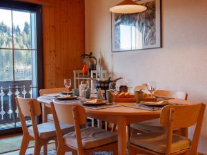 a dining room table with chairs and a table and a table and chairsktop at Apartment Dahlia by Interhome in Champoussin