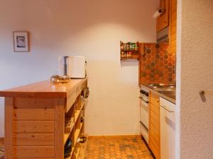a small kitchen with a counter and a sink at Apartment Dahlia by Interhome in Champoussin +29 photos