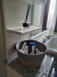 a basket sitting on a counter next to a bathroom sink at Casa Valeria in Sulmona +11 photos