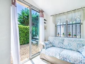 a living room with a couch and a window at Holiday Home Les Parcs de Gassin-1 by Interhome in Saint-Tropez +20 photos