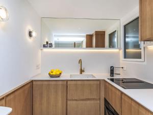 a kitchen with a sink and a mirror at Apartment Llafranc Beach by Interhome in Llafranc