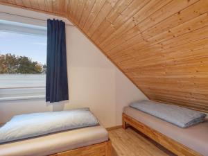 a small room with a bed and a window at Holiday Home Strandläufer by Interhome in Altefähr +38 photos