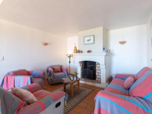 een woonkamer met banken en een open haard bij Villa La Baïassière by Interhome in La Nartelle