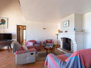 een woonkamer met banken en een open haard bij Villa La Baïassière by Interhome in La Nartelle