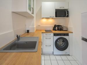 a kitchen with a sink and a washing machine at Apartment Parc de Pontaillac-31 by Interhome in Vaux-sur-Mer
