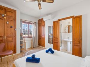 a bedroom with a bed with blue towels on it at Villa Moraira Magica by Interhome in Moraira