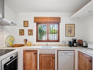 a kitchen with a sink and a window at Villa La Familia by Interhome in Benissa