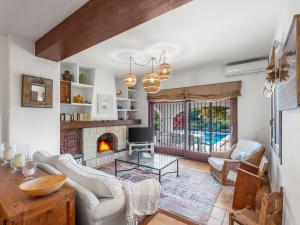a living room with a fireplace and a table at Villa La Familia by Interhome in Benissa +45 photos