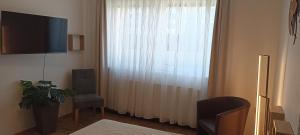 Μια τηλεόραση ή/και κέντρο ψυχαγωγίας στο 4 You Apartment in Leoben mit Balkon, Garten und kostenlosen Parkplatz
