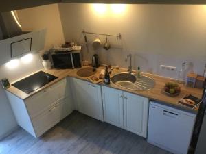 a kitchen with a sink and a microwave at Le cocon de Veyre in Martres-de-Veyre