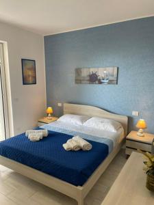Un dormitorio con una cama con dos toallas encima. en DonBà apartments, en Capo dʼOrlando