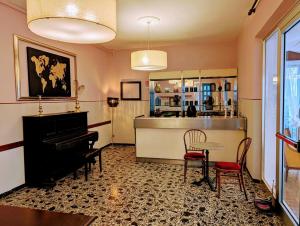 a living room with a piano and a table at VILLA ANTONIETTA Rooms & Coffee in Cesenatico