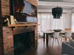 sala de estar con chimenea de ladrillo y mesa en Americana Manor, en Lubbock