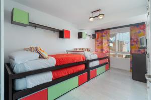 a bedroom with two beds with colorful blankets at Torremolinos 5 Rooms Junto al Mar in Torremolinos