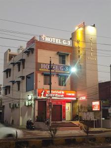 a hotel building on a city street at night at Hotel G-3 in Jalandhar