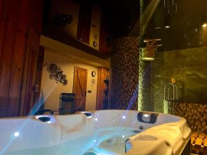 a white bath tub sitting in a bathroom at Pension Polonia in Vrchlabí +29 photos