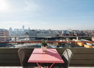 a pink table with a potted plant on a balcony at Central Four in Brescia +90 photos