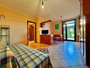 a bedroom with a bed and a kitchen with a table at Maisonette Rosa dei Venti in Carpi