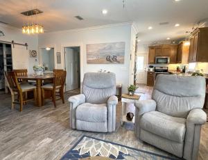 a living room with two chairs and a table at Rookery 7026 in Gulf Shores
