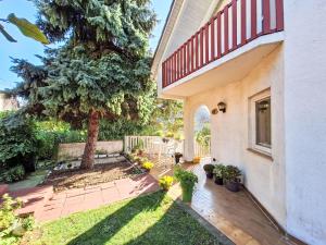 a backyard with a tree and a house at Apartment Bonika by Interhome in Fonyód